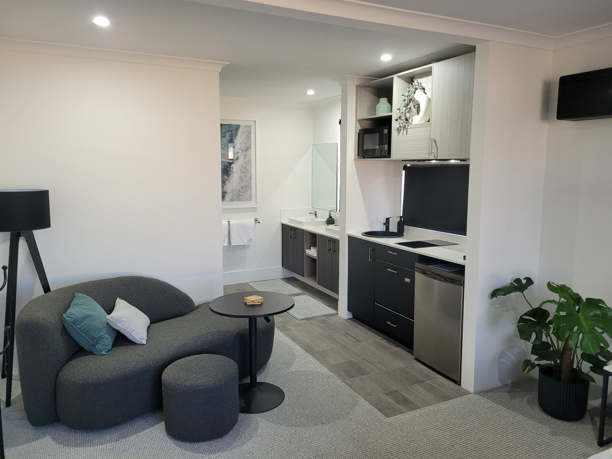 BRiX living area with curved sofa and adjoining kitchenette