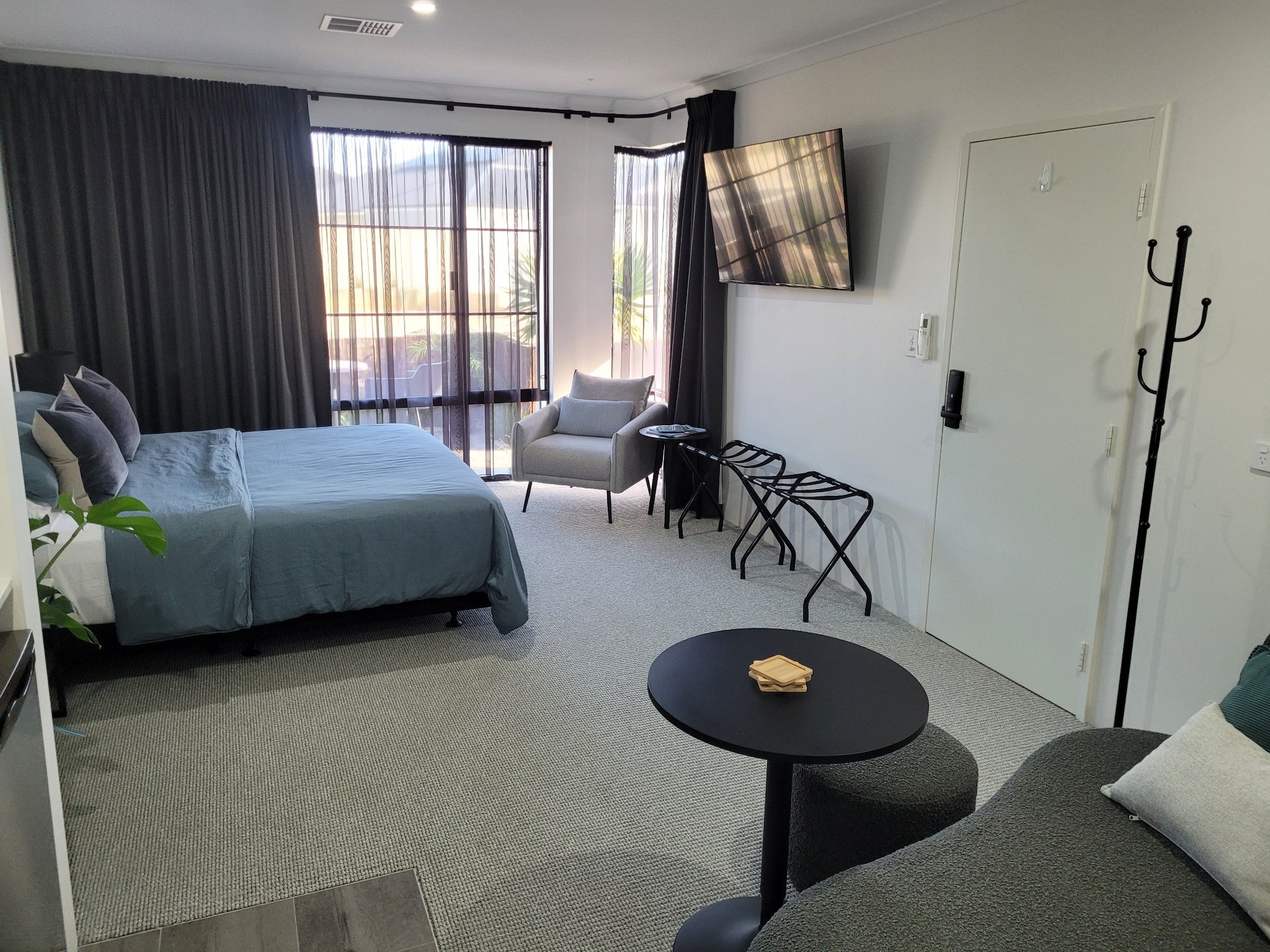 Wide view across the BRiX suite showing the king bed, seating and entry